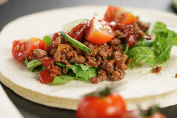 open tortilla with beef, frillice and vegetables