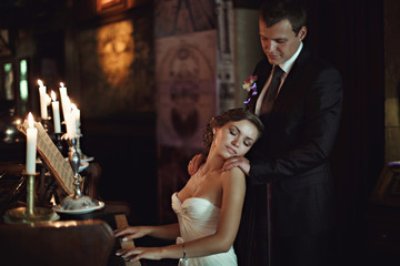Amazing bride is playing piano for her groom