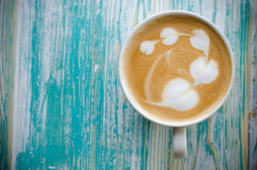 latte art in heart shape on wooden background