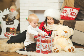 Happy young mother with her son opened christmas gift.