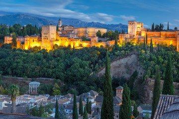 Fototapeta na wymiar Moorish palace and fortress complex Alhambra with Comares Tower, Alcazaba, Palacios Nazaries and Palace of Charles V and roofs of Albayzin during evening blue hour in Granada, Andalusia, Spain