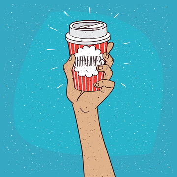 Extended upwards hand holding shiny trendy paper cup of coffee, on which the inscription Cheerfulness. Blue background. Handmade cartoon style
