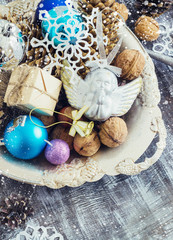 Christmas Composition of  balls, cones and snowflakes in a metal bowl. Vintage style. toning