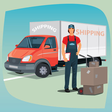 Young man in jumpsuit standing with clipboard. Nearby hand truck trolley with cardboard boxes. On background box truck or lorry. The concept of delivery or shipping