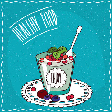 Natural yogurt with red currant and other berries in a glass, lie on lacy napkin. Blue background and lettering Healthy food. Handmade cartoon style