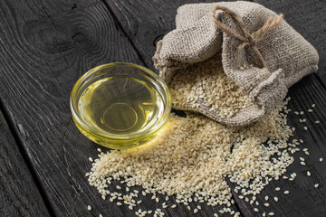 Sesame seeds in a bag and sesame oil in a bowl