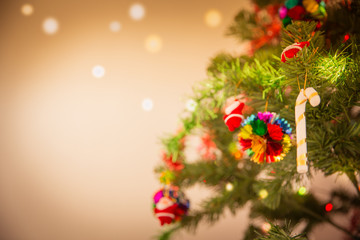 Decorated Christmas tree and gift on toned background