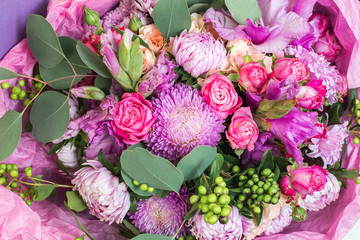 Close up of bouquet of bright not fresh flowers of different kinds.
