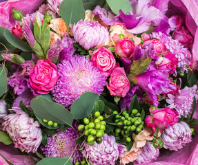 Close up of bouquet of bright not fresh flowers of different kinds.