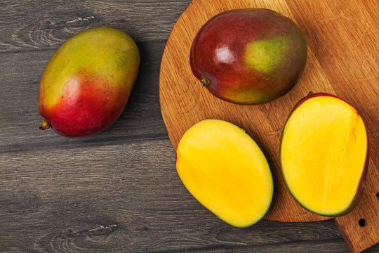 Fresh mango on a wooden cutting board. Healthy diet. Ripe fruit.