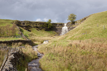 Small waterfall and overcast sky in Wensleydale, Yorkshire.
