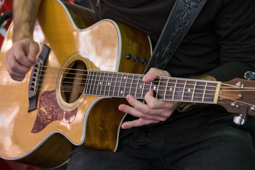 Obraz na płótnie Canvas Man plays the acoustic guitar