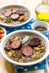 Lentil stew with carrots, potato, bell pepper and sausages