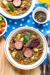 Lentil stew with carrots, potato, bell pepper and sausages