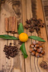 Cinnamon sticks, cocoa beans, star anise, hazelnuts on wooden background