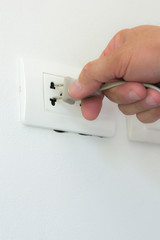 Inserting plug in outlet.