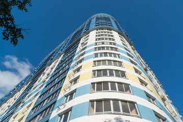 modern multi-storey residential building on background of blue sky