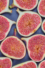 Pieces of fig on a stone board. Fruit background