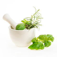 mortar with fresh herbs isolated on a white