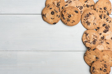 Vintage wooden background with tasty chocolate chip cookies, copy space