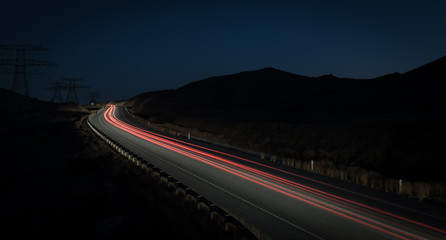 Fototapeta na wymiar Light trails from fast moving cars
