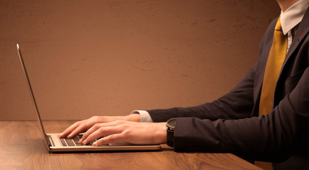 Businessman is suit working on laptop