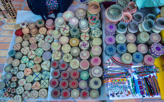 Taramuhara Indian-made handicrafts vended on sidewalk - Copper Canyon, Sierra Madre Occidental, Chihuahua, Mexico