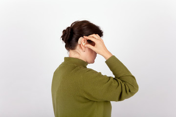 Fototapeta premium Woman inserting her hearing aid