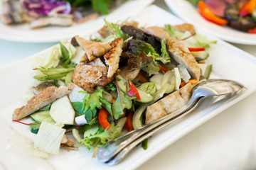 Vegetable salad on serving table. Sliced vegetables on a platter and spoon for eating. Herbal dietary a rural food. Food for Breakfast, lunch and dinner for weight loss and vegetarians.