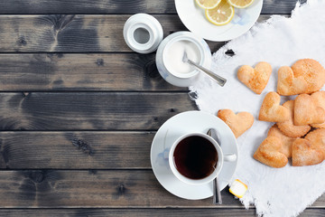 Foods of the Italian breakfast with tea and biscuits on an old wooden table, photographed from above