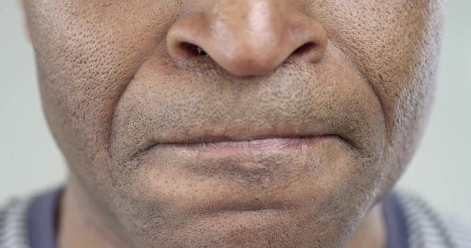The Man Strongly Displeased/Male African-American strongly angry. His lips pressed tightly together. Breathing frequent. He barely restrains himself