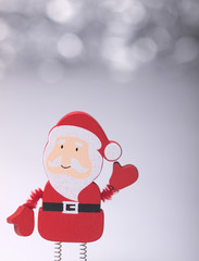 Santa Claus figure toy on sparkling bokeh background. Christmas ornaments