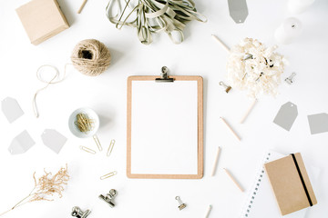 Flat lay, top view office table desk. feminine desk workspace mock up with clipboard, twine, pencils, floral bouquet, craft diary and clips on white background.