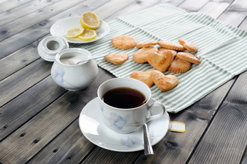 Foods of the Italian breakfast with tea and biscuits on an old wooden table