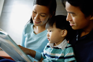 Family with one child reading a book
