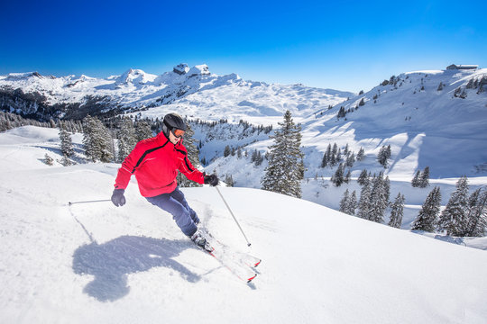 Young man skiing in Hoch-Ybrig ski resort, Swiss Alps