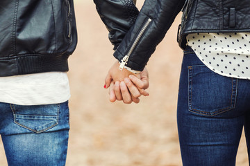 Close up of a hands of a couple held together.