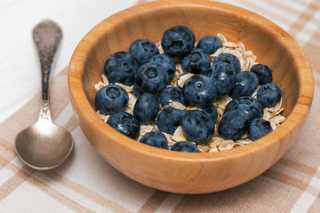 Healthy breakfast. Blueberry and granola, muesli with berries in a wooden bowl
