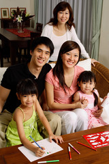 Three generation family looking at camera, portrait