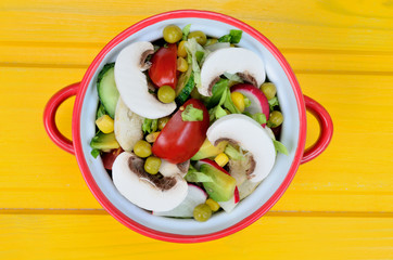 salad in saucepan on table