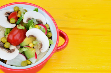 salad in saucepan on table