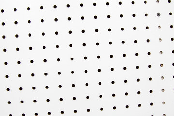 White pegboard mounted on a wall