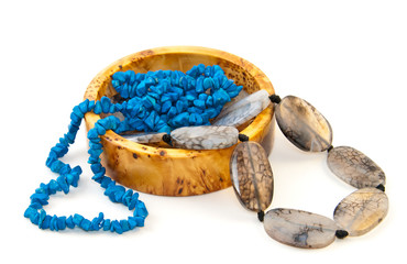 Agate necklace and birch yellow box isolated on white. Shallow depth of field. Focus on the closest beads.