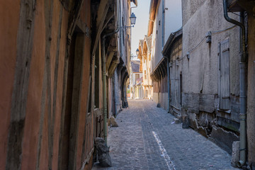 old medieval street with timbered houses in Troyes, France, suns