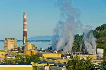 Power plants generating smokes at sunrise