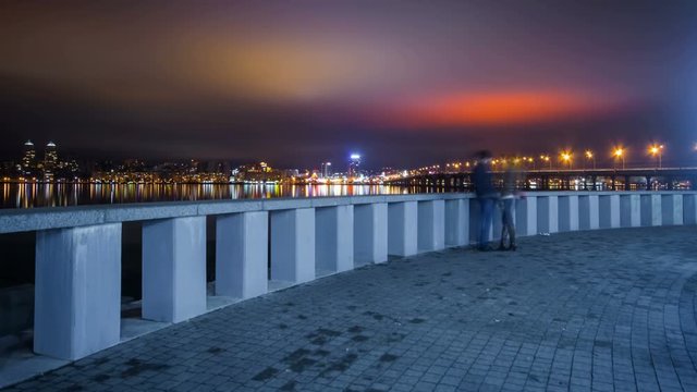 Young Couple On Embankment Of Dnepr River At Night, Time Lapse
