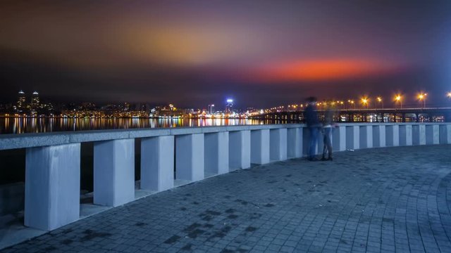 Young Couple On Embankment Of Dnepr River At Night, Time Lapse
