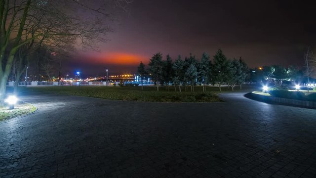 People Go Along On Embankment Of Dnepr River At Night, Time Lapse
