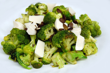 healthy lunch, broccoli with fresh mozzarella and pumpkin seeds