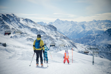 Beautiful view of the snow-covered mountains and skiers in Italy